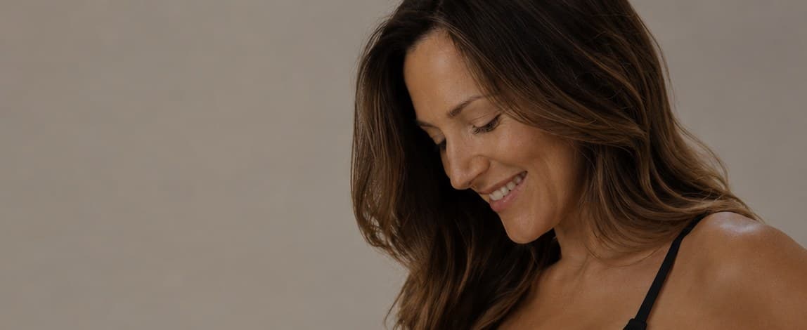 A smiling pregnant woman with healthy, glowing skin